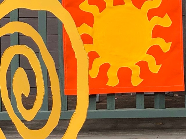 An orange swirl and sun
